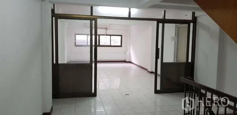 Home Office for rent or sale in Bang Na, Bangkok - Landing area with sliding glass doors leading to a bright office room.