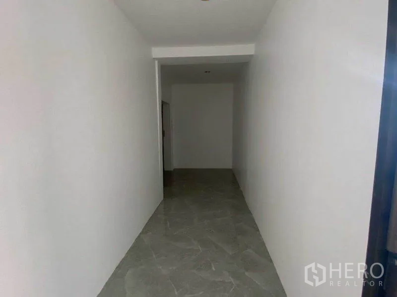 Office Space for rent in Watthana, Bangkok - Narrow corridor with gray tile floor leading to the glass-door office entrance.