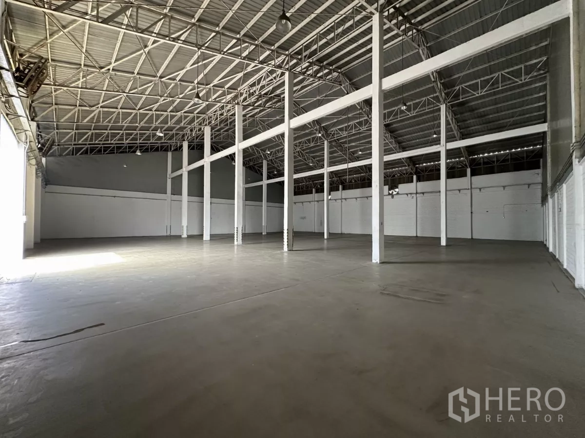 Warehouse for rent in Phra Khanong, Bangkok - Bright high-clearance warehouse interior with steel beams and open layout suitable for racking and staging.