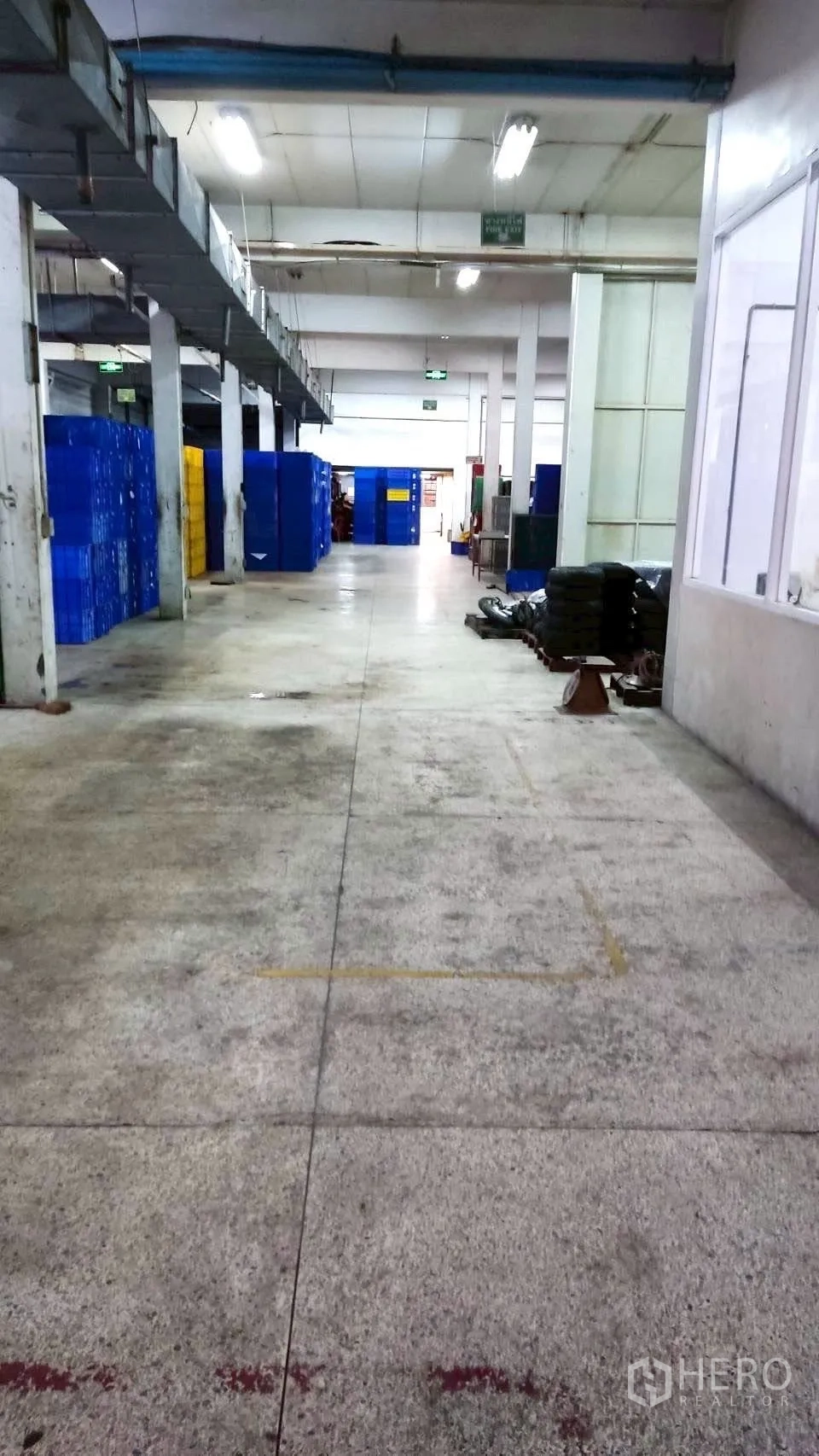 Factory for sale in Lat Krabang, Bangkok - Long interior aisle with overhead ducting, fluorescent lights, and side windows.