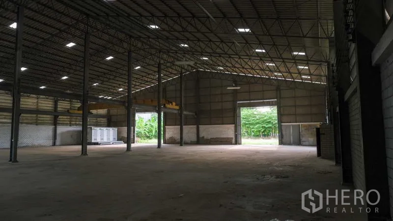 Factory for rent in Bang Phli, Samut Prakan - Warehouse hall with large doorways at both ends and natural light panels.