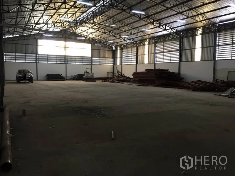 Warehouse for rent in Saphan Sung, Bangkok - Wide warehouse bay with high ceiling, ventilation panels, and large open floor suitable for storage or light industry.