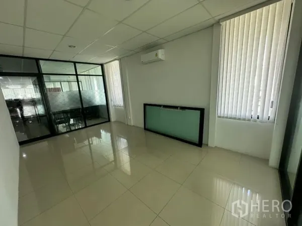 Office Space for rent - Compact private office with vertical blinds, glass partition and wall-mounted AC unit.