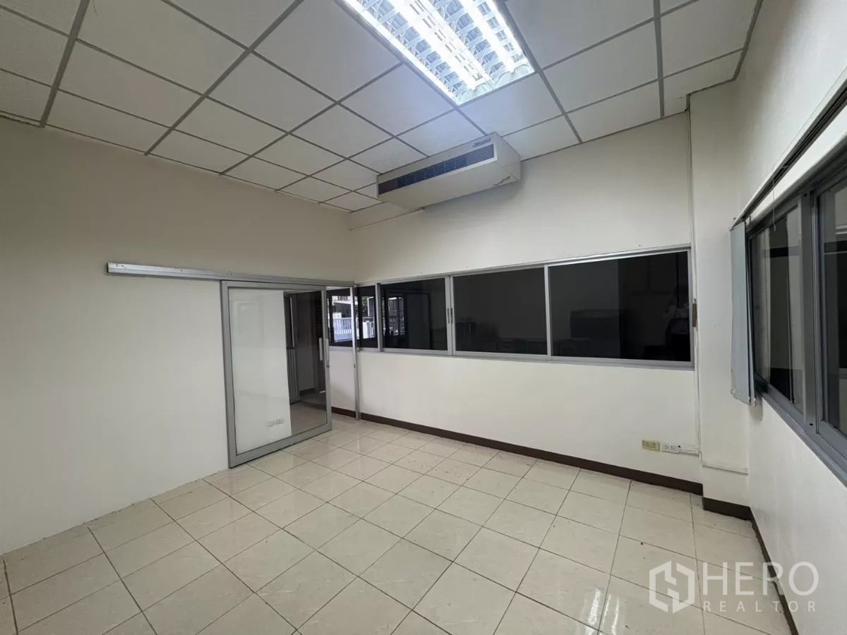 Warehouse for rent in Bang Phli, Samut Prakan - Private office room with sliding windows and ceiling air conditioner.