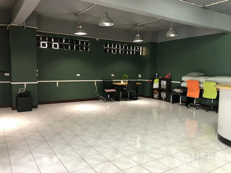 Warehouse for rent in Chatuchak, Bangkok - Spacious multipurpose hall with dark green walls, pendant lights and glossy tile floor.