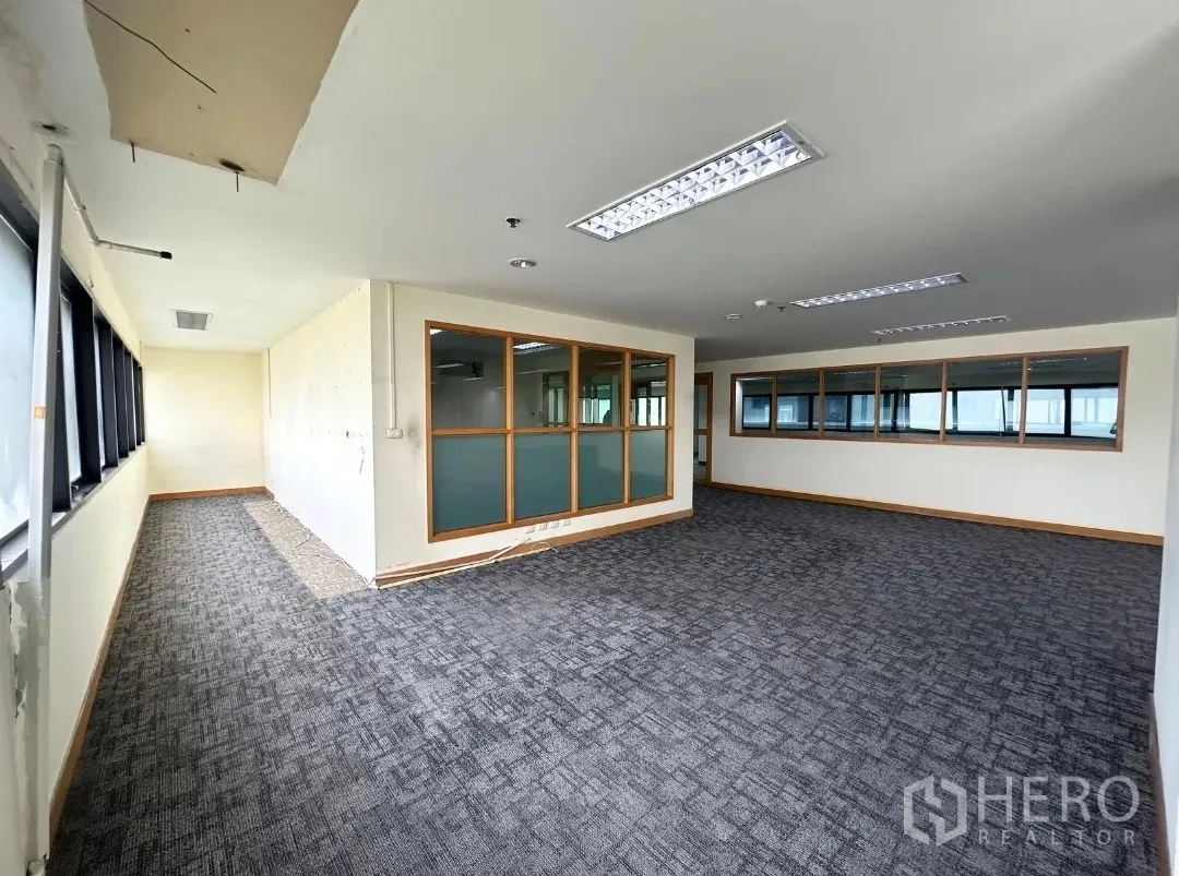 Office Space for rent in Bang Rak, Bangkok - Open-plan office with carpet tiles and internal glass partitions.