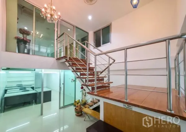 Office Space for rent in Khlong Toei, Bangkok - Double-height area with wooden staircase and steel railing leading to mezzanine and glass rooms.