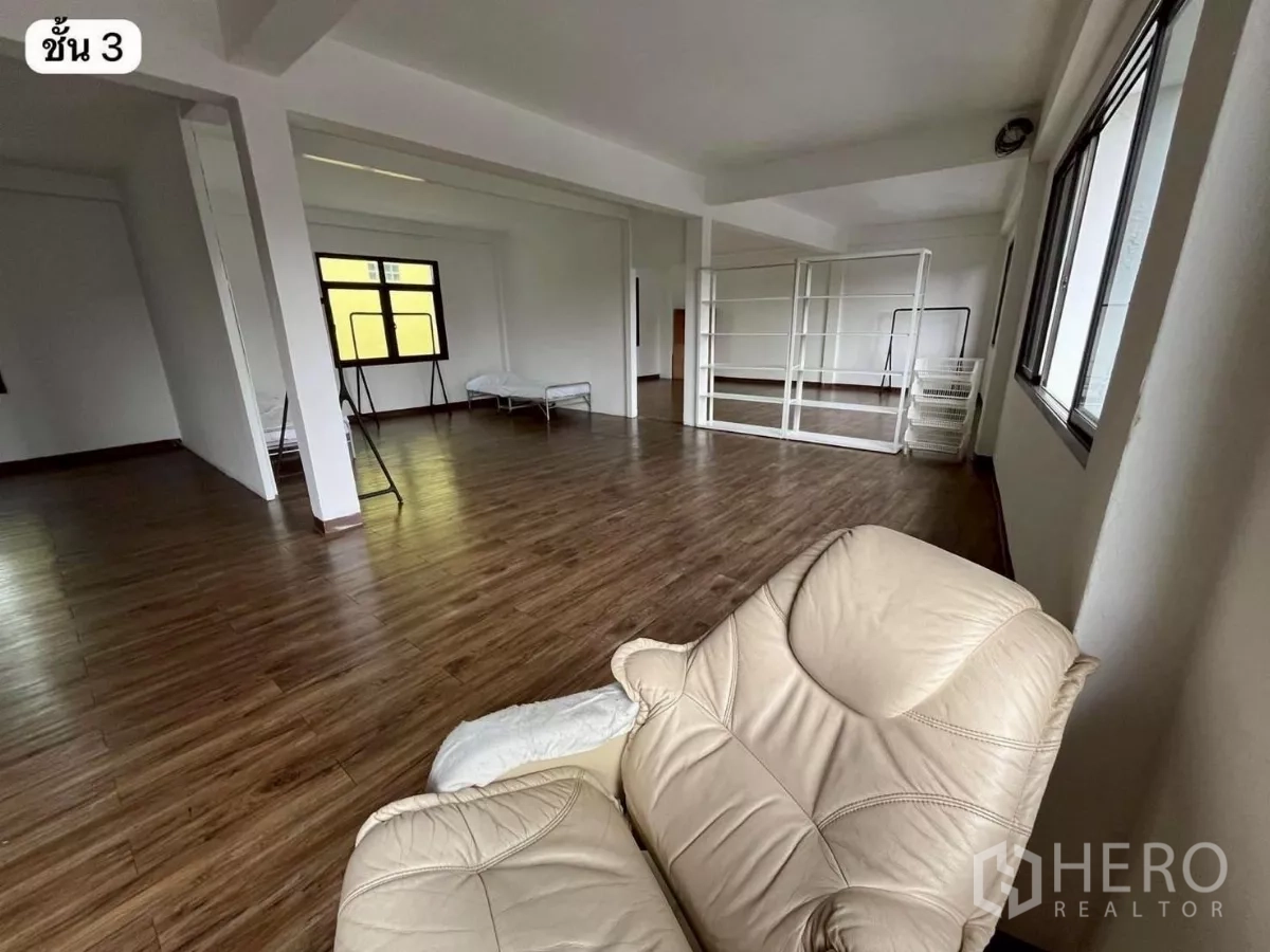 Shophouse for rent or sale in Khlong Toei, Bangkok - Flexible third-floor space with partial partitions, shelving, and wood floors.