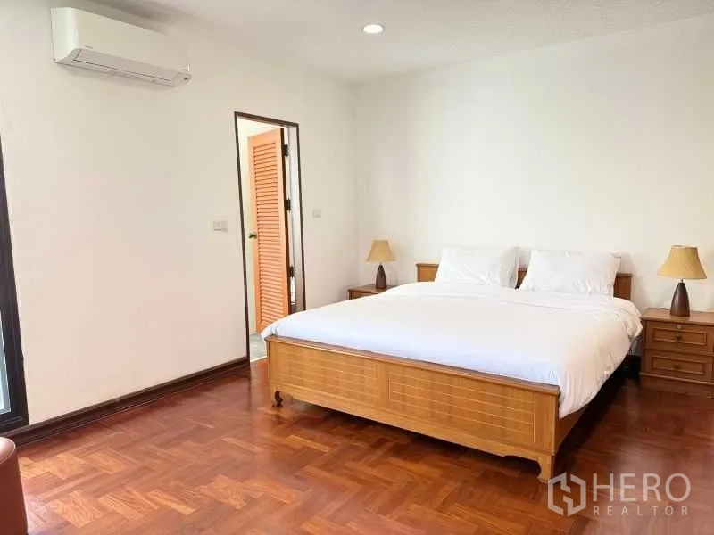 Condominium for rent - Primary bedroom with king bed, bedside tables, and door to ensuite bathroom.