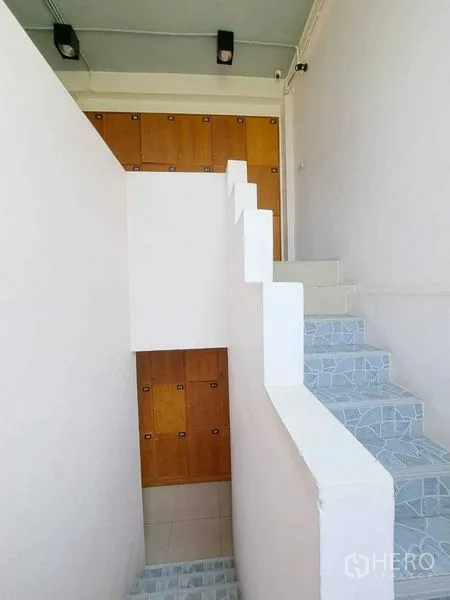 Retail Space for rent in Khlong Toei, Bangkok - Bright stairwell with patterned steps leading to upper floors and built-in wooden lockers.