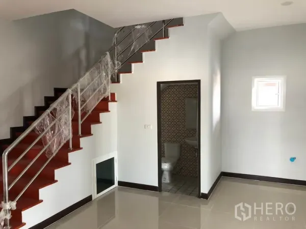 Factory for rent or sale in Bang Len, Nakhon Pathom - Office interior with tiled floor, stainless-steel staircase and under-stair bathroom.