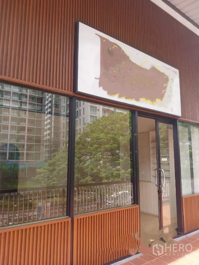 Retail Space for rent - Street-facing retail storefront with full-height glass and wood slat facade in Watthana, Bangkok.