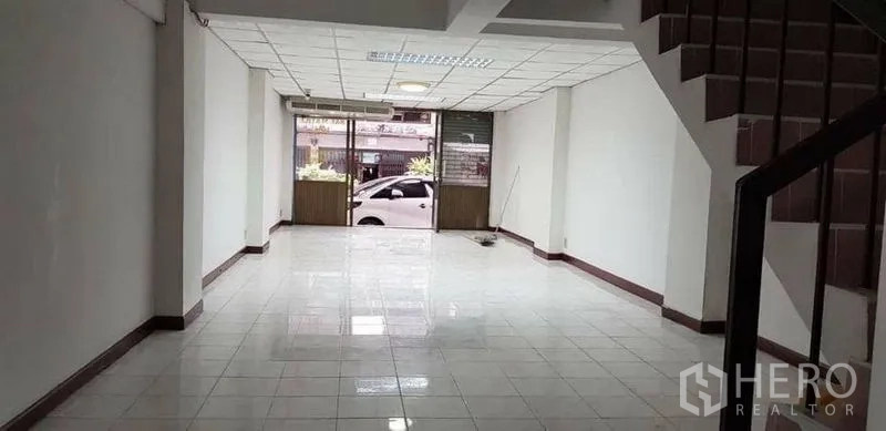 Home Office for rent or sale in Bang Na, Bangkok - Street-facing storefront with large windows and tiled showroom space.