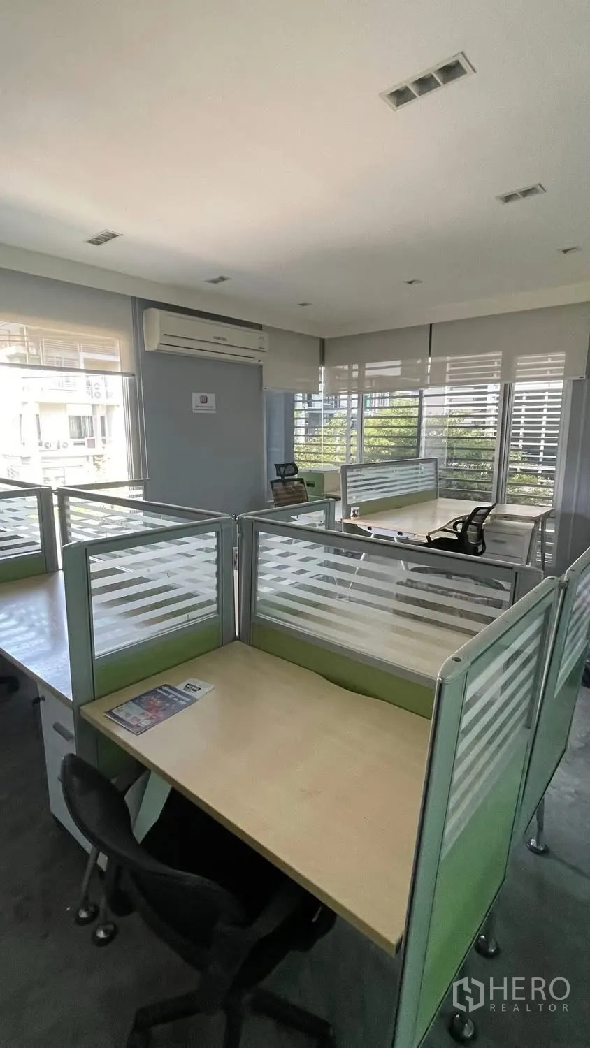 Home Office for rent or sale in Wang Thonglang, Bangkok - Bright open-plan office with partitioned workstations, windows, and blinds.