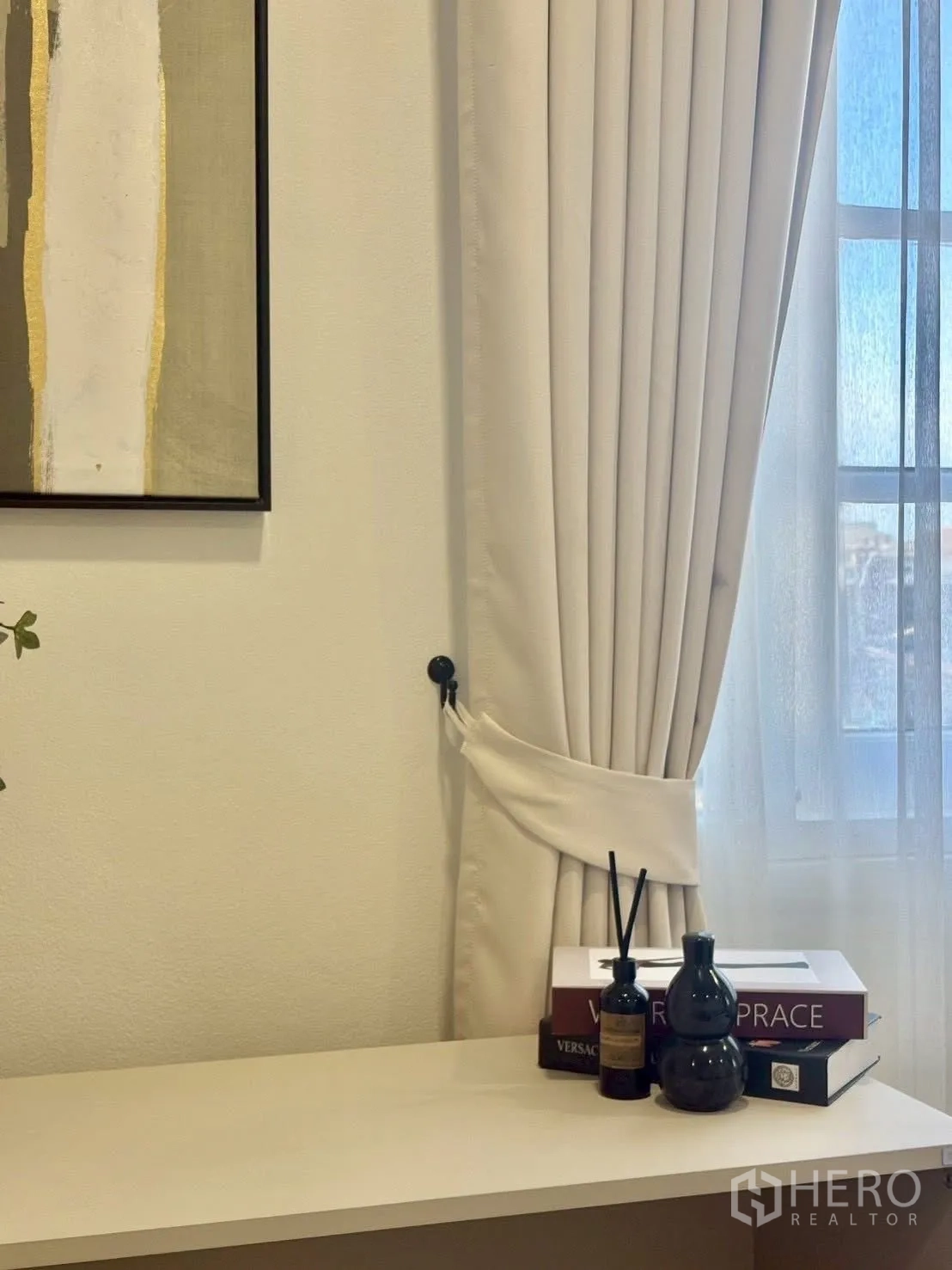Townhouse for rent in Huai Khwang, Bangkok - Detail of curtain tie-back and console decor by a window.