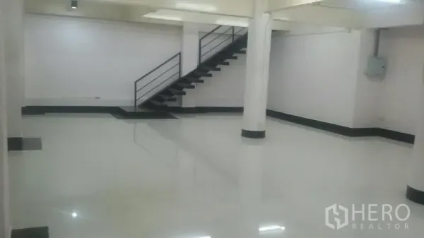Office Space for rent in Sathon, Bangkok - Open office zone with white columns and a metal staircase leading to an upper area.