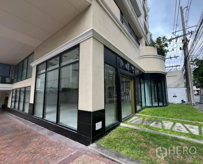 Retail Space for rent in Watthana, Bangkok - Exterior corner of building with wraparound glazing and grass verge.
