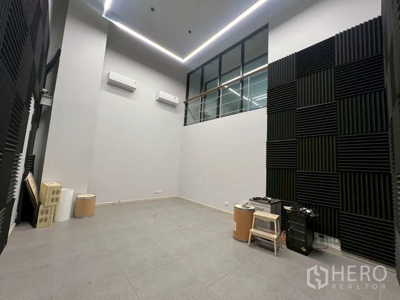 Home Office for rent or sale in Phra Khanong, Bangkok - High‑ceiling room with acoustic panels and split air‑conditioners.