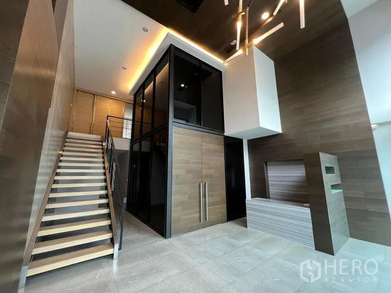 Home Office for rent in Bueng Kum, Bangkok - Double-height reception with sculptural lights, wood accents and central staircase.