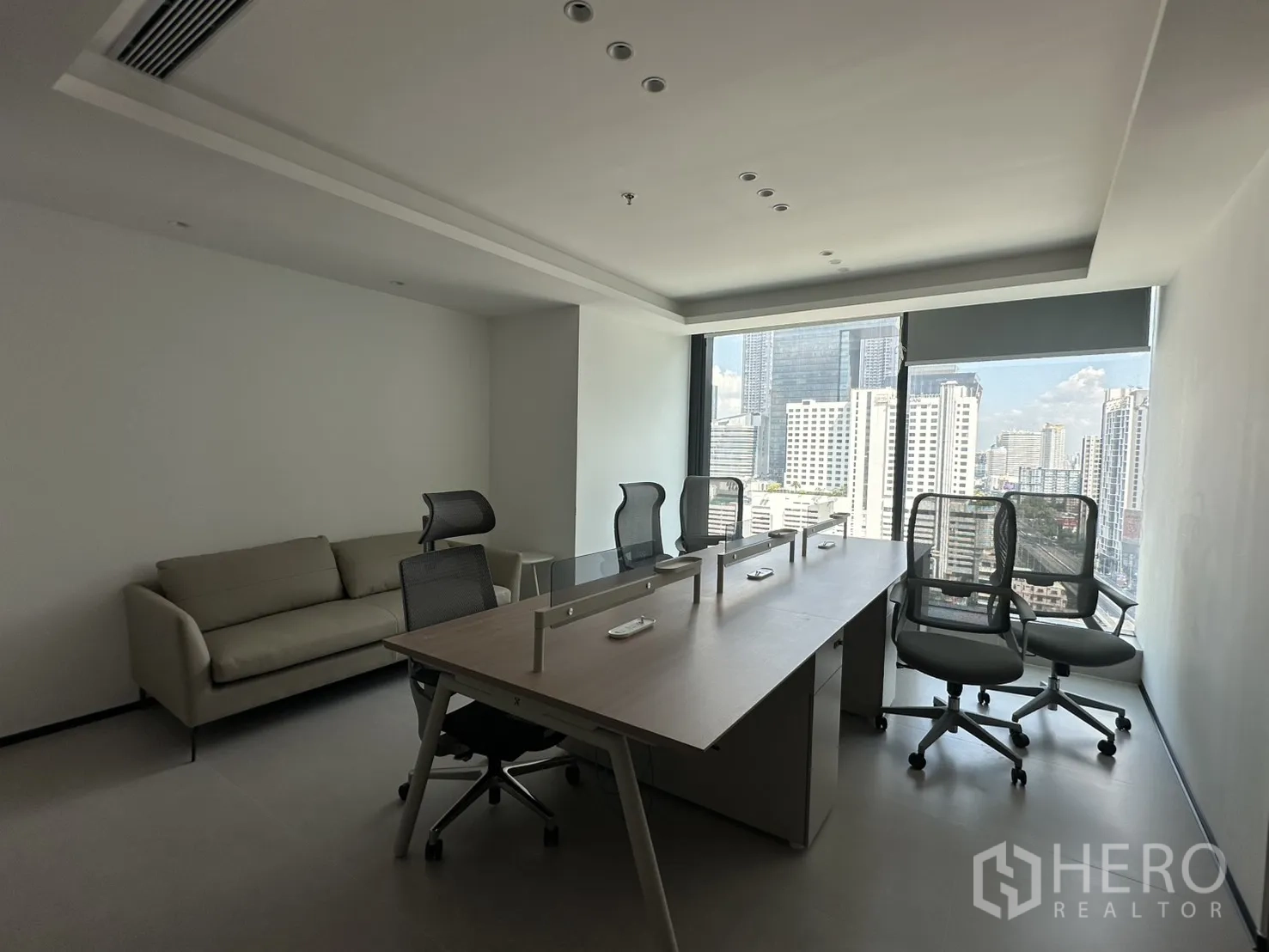 Office Space for rent in Din Daeng, Bangkok - Shared office area with long desks and task chairs from another angle.