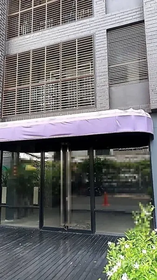 Retail Space for rent in Khlong Toei, Bangkok - Street-level shopfront with glass doors and purple awning on modern facade.