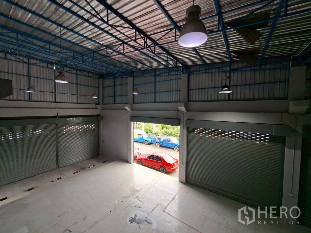 Warehouse for rent in Suan Luang, Bangkok - Open loading bay with roller doors, high-bay lights and direct street access.