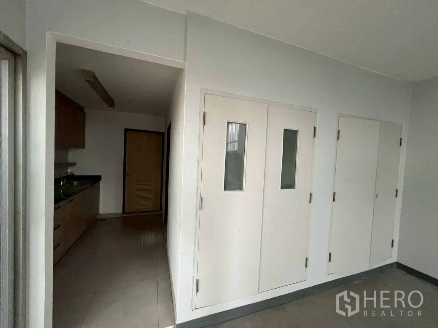 Office Space for rent in Watthana, Bangkok - Entry corridor showing doors and access to pantry and storage.