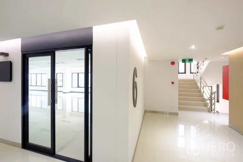 Office Space for rent in Chatuchak, Bangkok - Bright corridor with glass entry door marked 6 and stairs beside it.