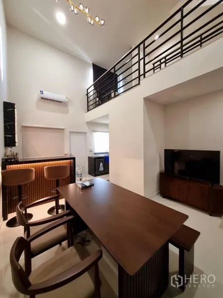 Townhouse for rent - Double-height dining area with loft, home bar and TV corner.