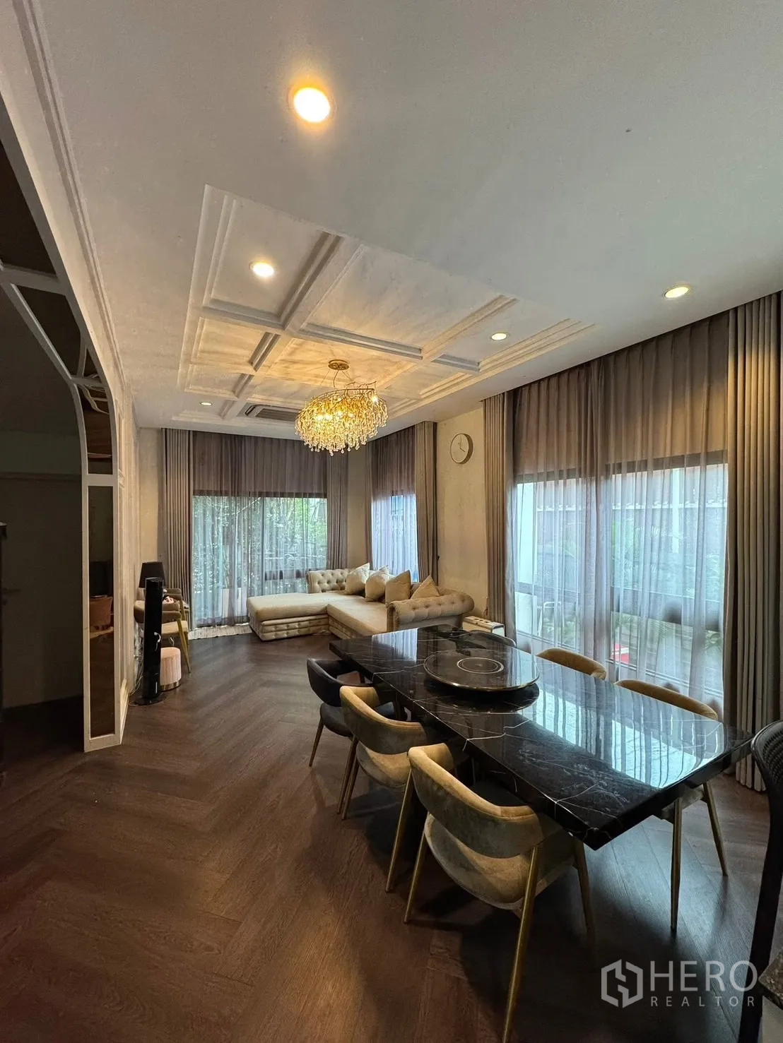 Detached House for sale in Mueang Pathum Thani, Pathum Thani - Dining and lounge corner with chandelier, bay windows and wood floors.