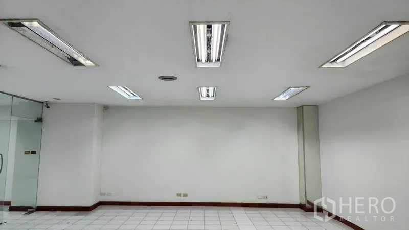 Office Space for rent or sale in Khlong Toei, Bangkok - White office room ceiling with multiple recessed fluorescent light fixtures.