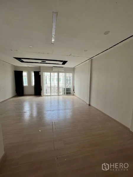 Home Office for rent - Large upper-floor workspace with recessed ceiling detail and balcony doors providing natural light.