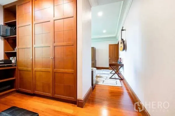 Detached House for sale - Hallway with built-in wooden wardrobes and hardwood floors.