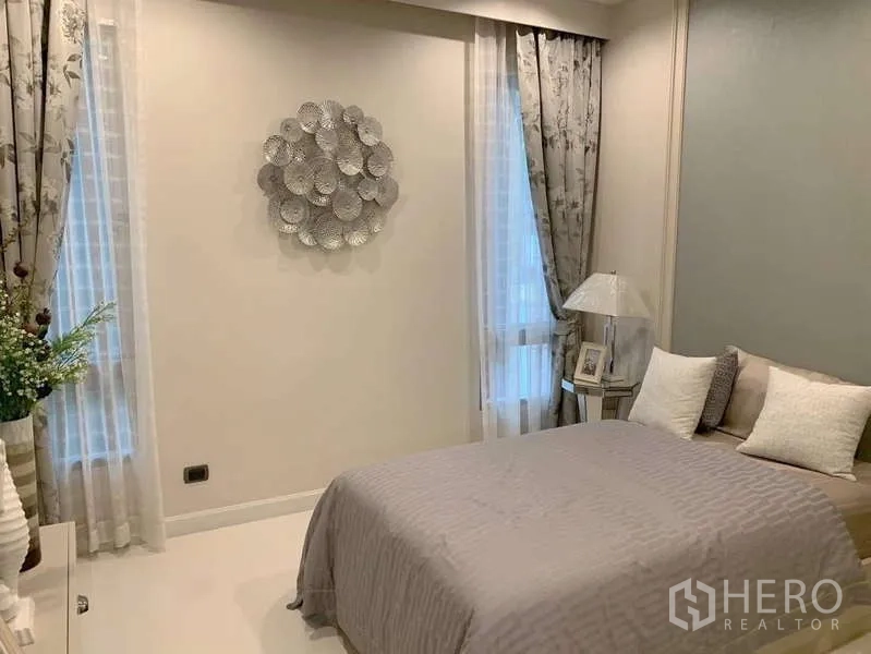 Detached House for rent or sale in Bang Phli, Samut Prakan - Quiet bedroom with light curtains, wall art and bedside table.