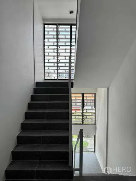 Home Office for rent or sale - Modern stairwell with dark steps and floor-to-ceiling louvered windows bringing natural light.