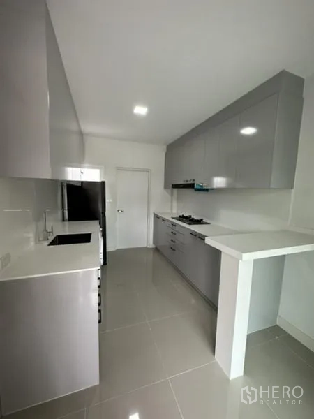 Townhouse for rent in Bang Phli, Samut Prakan - Full view of modern galley kitchen with extensive cabinets.