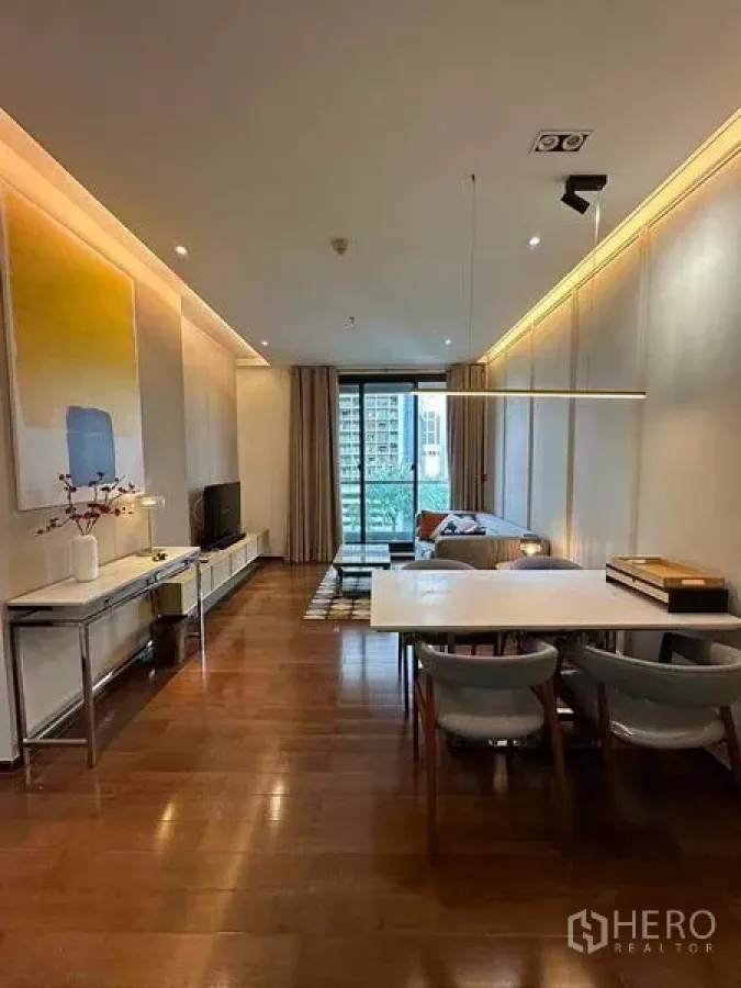 Condominium for rent in Khlong Toei, Bangkok - Dining zone with modern pendant light, four chairs and wood flooring.