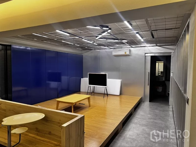 Office Space for rent or sale in Suan Luang, Bangkok - Small presentation room with raised wooden platform and TV display.