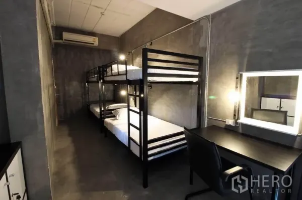 Office Space for rent or sale in Bang Rak, Bangkok - Dorm-style room featuring black metal bunk beds and a study desk.