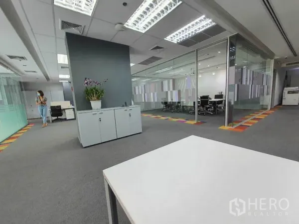 Office Space for rent in Ratchathewi, Bangkok - Open-plan workspace with grey carpet, storage cabinet, and glass-walled meeting rooms.