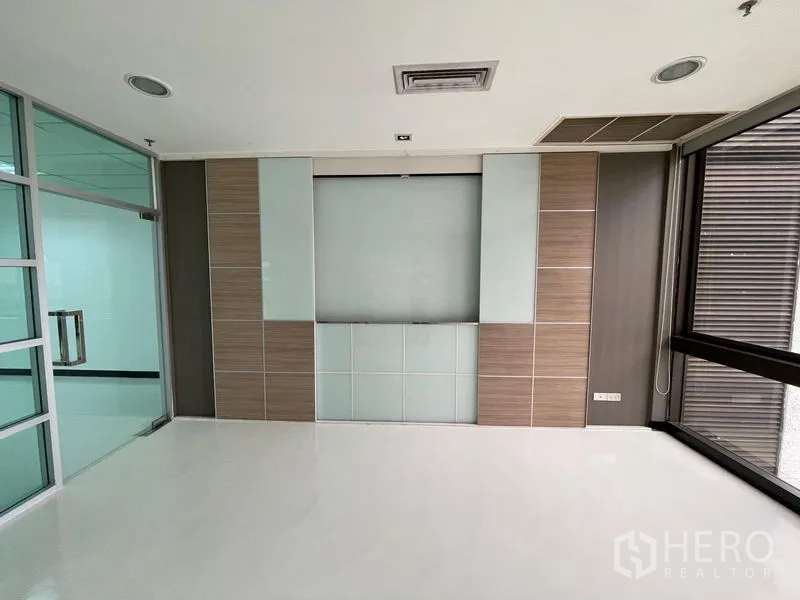Office Space for rent in Bang Rak, Bangkok - Reception or manager’s room with wood panels and a glass partition.