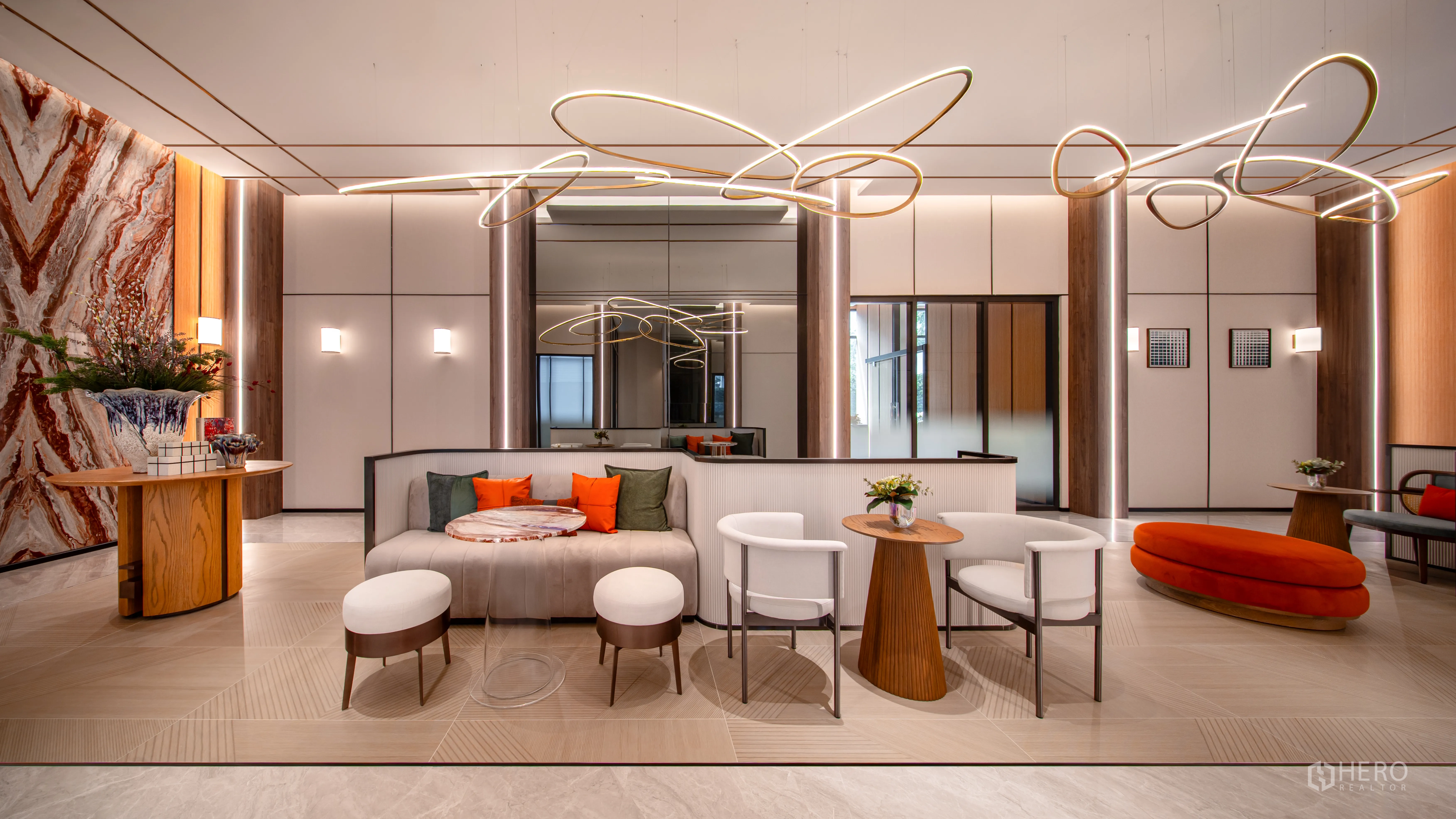 Condominium for sale in Khlong Toei, Bangkok - Luxurious condominium lobby with sculptural ceiling lights, lounge seating, and marble accents.