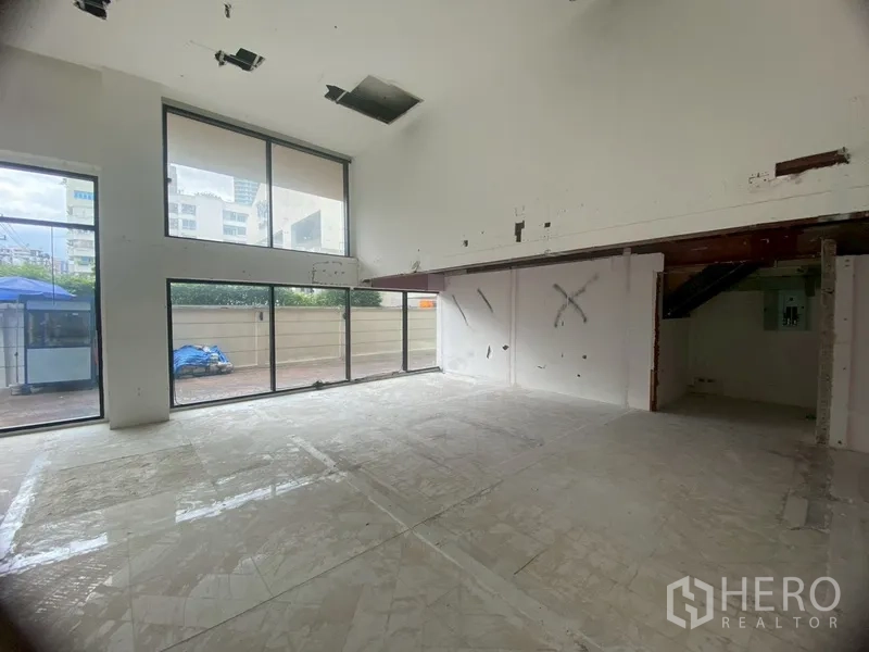 Retail Space for rent in Watthana, Bangkok - Double-height interior with full-height windows and mezzanine area.