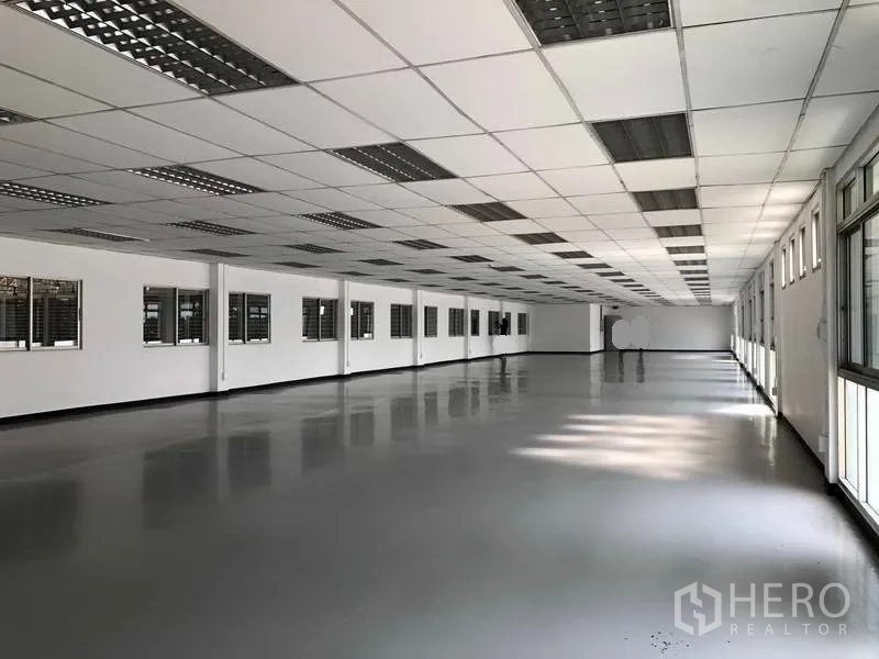 Factory for rent or sale in Phra Nakhon Si Ayutthaya - Long upstairs office or cleanroom with dropped ceiling and continuous windows.