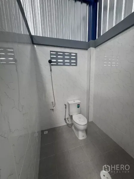 货栈 出租在Bang Phli, Samut Prakan - 仓库内干净的卫生间，瓷砖地面，坐便器与喷枪，设通风窗。