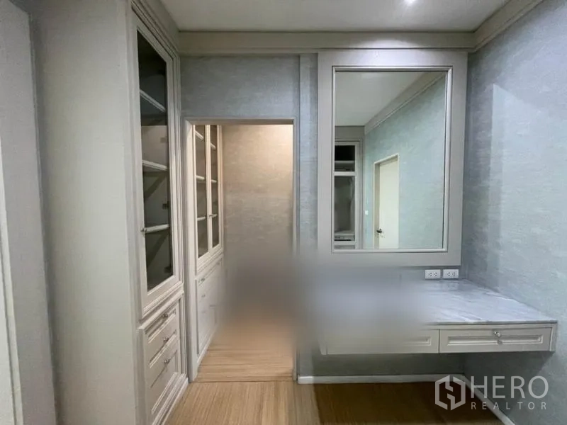 Townhouse for sale in Suan Luang, Bangkok - Dressing area with built-in vanity, large mirror and glass-door wardrobes.