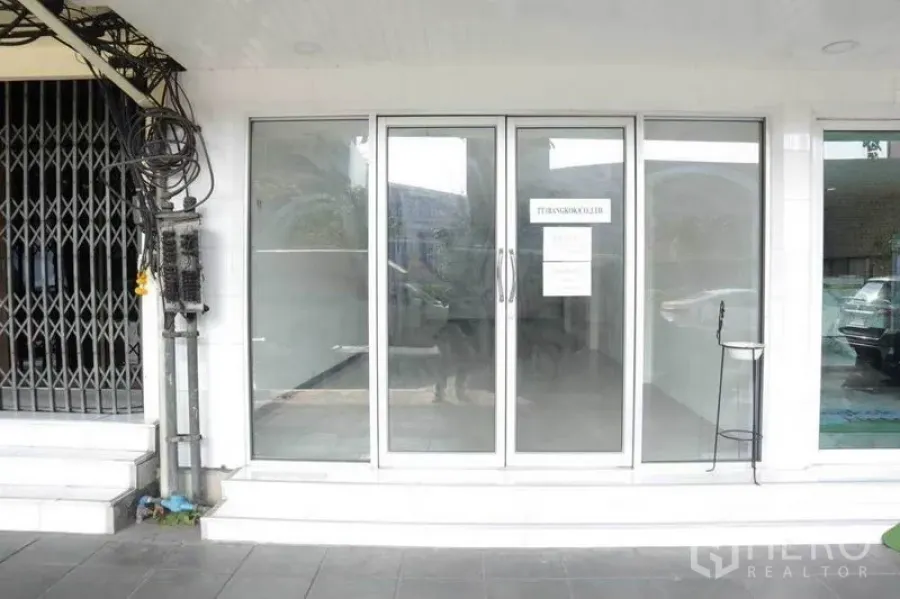Retail Space for rent in Watthana, Bangkok - Street-level shopfront with wide sliding glass doors and a small step entry.