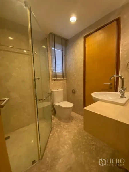 Condominium for rent in Watthana, Bangkok - Covered balcony with a plunge tub overlooking the pool deck and low-rise neighborhood.