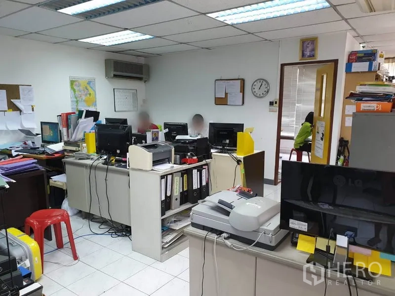 Office Space for rent in Bang Kapi, Bangkok - Open-plan office with desks, computers, filing cabinets and wall-mounted air conditioning under fluorescent lights.
