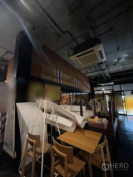 Retail Space for rent in Watthana, Bangkok - Dining area with high ceiling, cassette air-conditioning and wooden furniture.